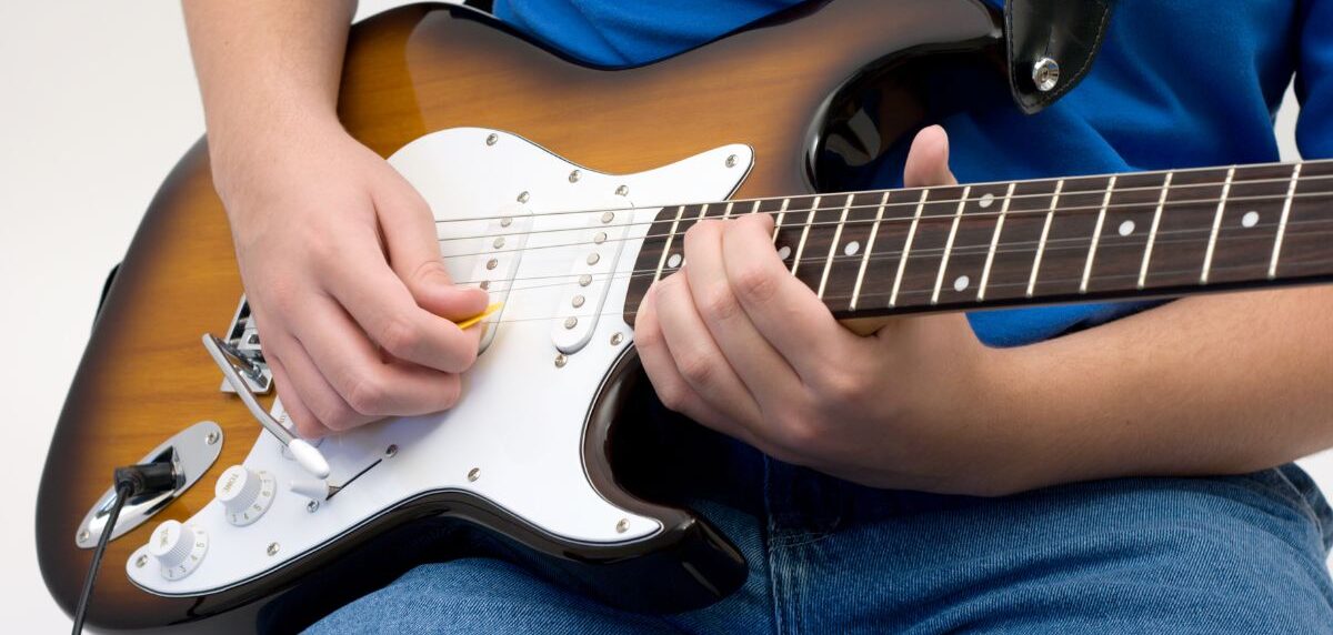 A boy playing electric guitar
