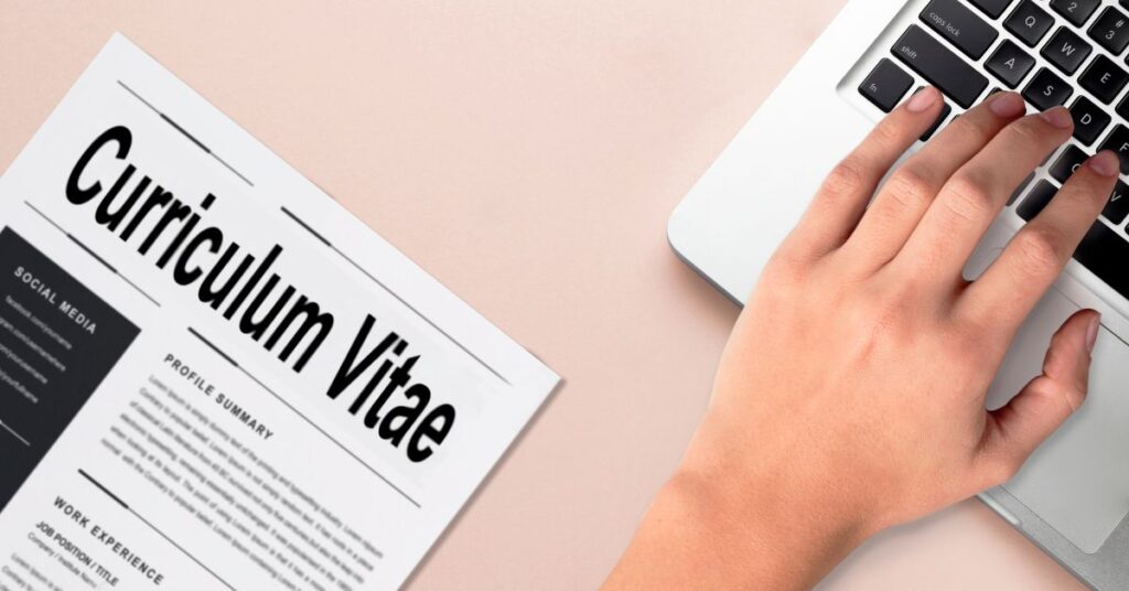 Close-up of hands typing an internship cover letter on a laptop